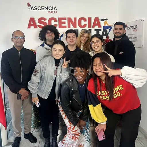 Group of Ascencia Malta students and staff smiling together at the campus, celebrating community, diversity, and student life