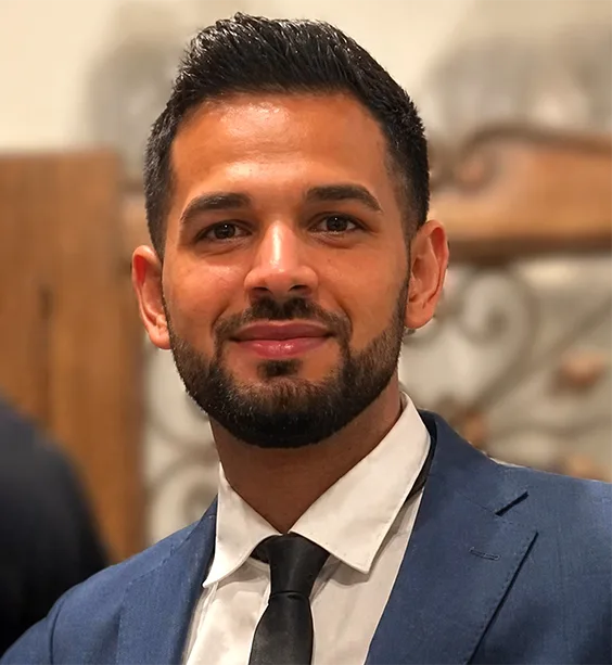 Abel, Marketing Manager at Ascencia Malta and Employee of the Month, smiling in formal business attire