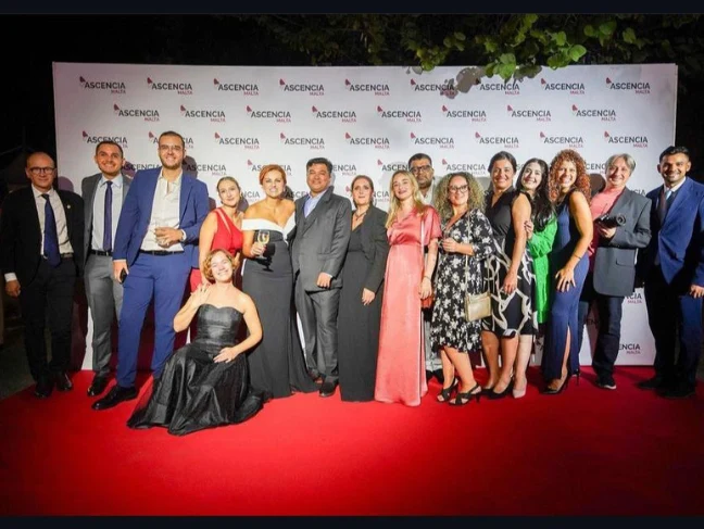 Ascencia Malta staff and guests posing together at a formal awards event