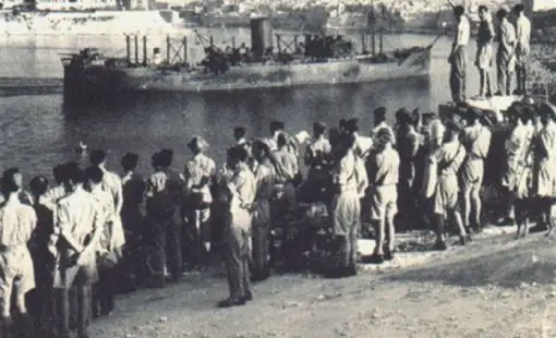 Historical image of the Santa Marija Convoy arriving in Malta’s Grand Harbour in 1942, with people gathered along the waterfront during World War 2