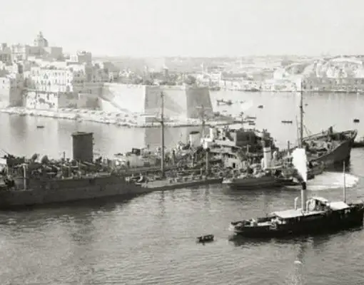 Black and white photograph of ships in Malta’s Grand Harbour during World War II, representing the Santa Marija Convoy and historic wartime supply mission