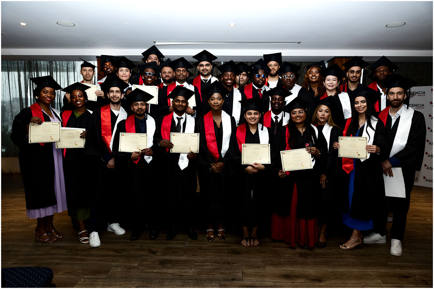 Graduates posing with certificates at Ascencia Malta graduation ceremony