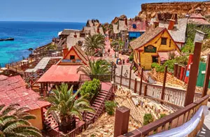 Colourful seaside buildings of Popeye Village, the famous film set attraction in Malta.