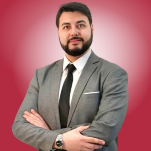 Dariush Rahiminia, Academic Manager at Ascencia Malta, in a professional portrait with folded arms.
