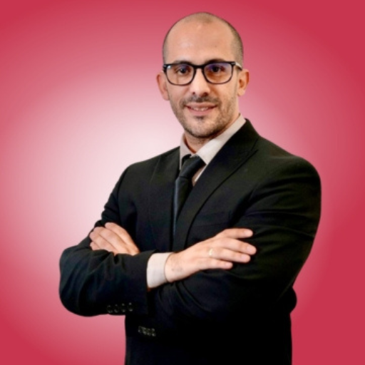Gianluca Abela, Head of Academics at Ascencia Malta, in a professional portrait with folded arms.